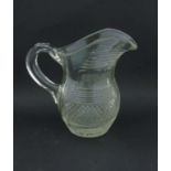 A 19thC clear cut glass crystal jug with loop handle.