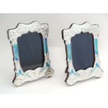 A pair of silver photograph frames with butterfly and floral decoration and Art Nouveau style