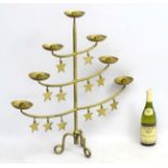 A cast iron gilt painted floor standing candelabra formed as a stylised Christmas tree with 7
