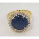 A 14ct gold ring set with blue stone cabochon with sapphire landi like star ,