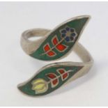 A white metal ring with enamel decoration.