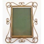 A late Victorian brass easel back photograph frame with decorative wirework border to frame,