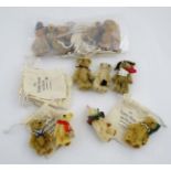 A collection of 12 'The Teddy Bear Museum Showcase' small bears with poster label (12)