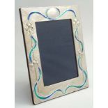 A silver photograph frame with Art Nouveau style enamel decoration.