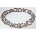 An unusual white metal choker / necklace with mythical male mask and figural decoration.