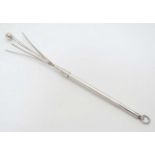 A silver and white metal swizzle stick 3 1/4" long (closed) CONDITION: Please Note