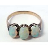 A yellow metal ring set with three graduated opals CONDITION: Please Note - we do