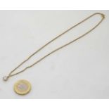 An 18ct gold chain set with a diamond solitaire pendant approx 1/4" dimeter CONDITION: