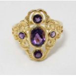 A silver gilt ring set with amethysts.