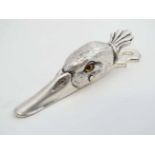 A silver plate desk top letter/ paper clip formed as a ducks head with glass eyes.