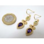 A pair of gilt metal drop earrings set with amethysts peridot and seed pearls 1 1/2" long