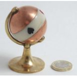 An early 20th C copper and brass 'globe' bridge card game trump marker,