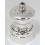 A silver plate pepper mill.