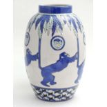 A 21st C blue and white art deco style monkey vase decorated with monkey motif,