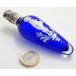 A blue glass scent / perfume bottle with Mary Gregory style decoration surmounted by a white metal