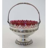 WMF : A silver plate bowl of basket form with cranberry glass liner.