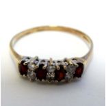 A 9ct gold ring set with garnets and white stones CONDITION: Please Note - we do