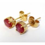 A pair of gilt metal stud earrings set with red stones CONDITION: Please Note - we