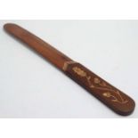 An inlaid hardwood page turner with acorn and oak leaf decoration to handle.
