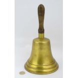 A large hand bell with wood handle,