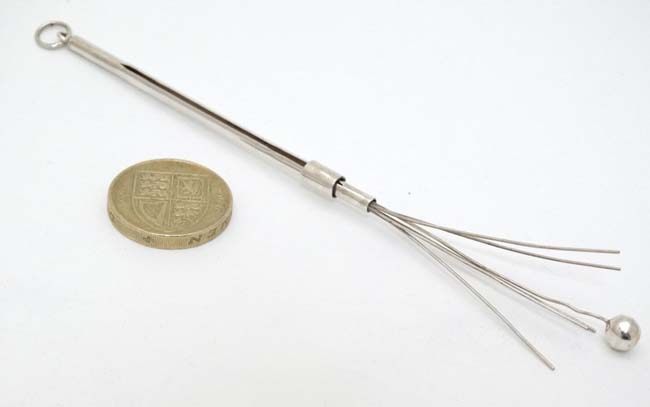 A silver and white metal swizzle stick 3 1/4" long (closed) CONDITION: Please Note - Image 3 of 4