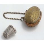 Needlework / Sewing : A Victorian gilt metal thimble case of egg form with floral decoration and