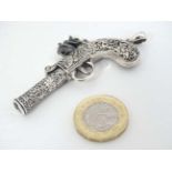 A novelty 'Sterling' silver whistle formed as a flintlock pocket pistol.