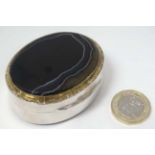 A silver and agate snuff box of oval form with silver gilt detail.