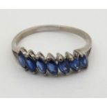 An 18ct white gold ring set with 7 blue stones CONDITION: Please Note - we do not