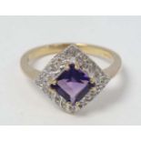 A 9ct gold ring set with central amethyst bordered by chip set diamonds CONDITION: