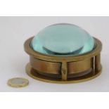 A 21st C brass compass with magnifying glass bubble,