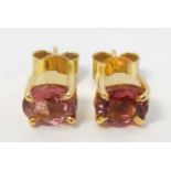 A pair of gilt metal stud earrings set with pink stones CONDITION: Please Note -