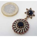 A silver gilt pendant set with blue red and white stones,