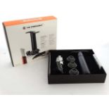 A 'Le Cruset' compact wine accessories gift set, to include a corkscrew, wine pump,
