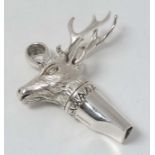 A novelty silver whistle with stag head.