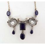 A silver pendant set with amethysts and pearls on a silver gilt chain 17" long