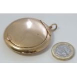 A 9ct gold compact of circular form with hinged lid opening to reveal mirror within 2" diameter