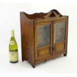 An early 20thC oak smokers compendium / cabinet,