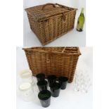 A wicker picnic basket with provision for 3 bottles, together with 2 cut glass decanters,