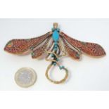 A gilt metal brooch / pendant formed as a dragon fly with enamel and turquoise decoration.