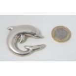 A Mexican silver brooch formed as a dolphin.