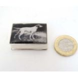 A .925 silver pill box with enamel monochrome image to top of a pointer dog. 21stC.