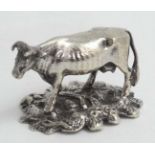 A white metal miniature model of a cow 2 1/4" long CONDITION: Please Note - we do