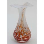 Scandinavian Glass : An art glass vase with orange red and white flecked decoration and flared rim.