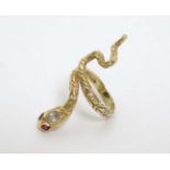 A 14k gold ring formed as a snake with set with white stone and ruby eyes CONDITION: