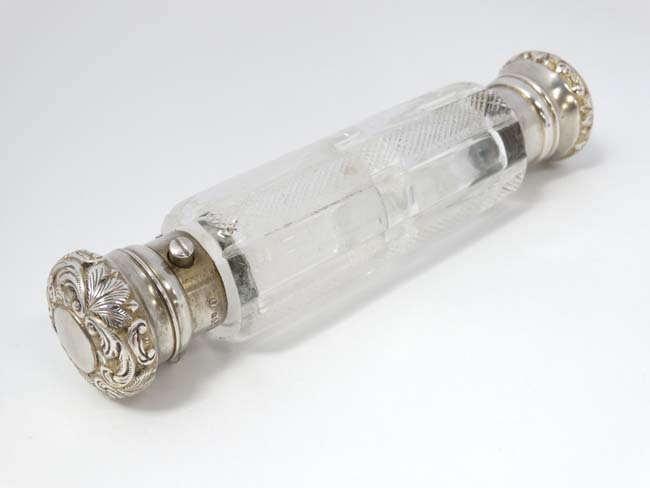 A Victorian double ended cut glass scent / perfume flask with silver ends hallmarked London 1890