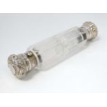 A Victorian double ended cut glass scent / perfume flask with silver ends hallmarked London 1890