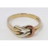 A 9ct gold ring with tri colour gold knot decoration to top.
