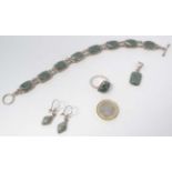 A silver suite of jewellery comprising ring, earrings,