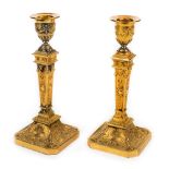 *Candlesticks. A pair of Adams style ormolu candlesticks, circa 1820s, finely cast with rams